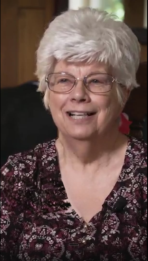 Ann Wilkinson of Aurora, CO smiling in her living room while sharing her HomePride shower remodel testimonial