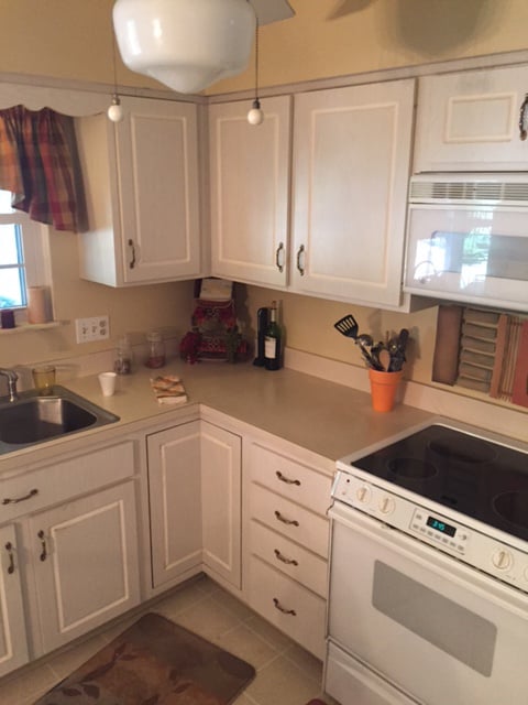 Oak cabinets with white appliances before cherry cabinet refacing