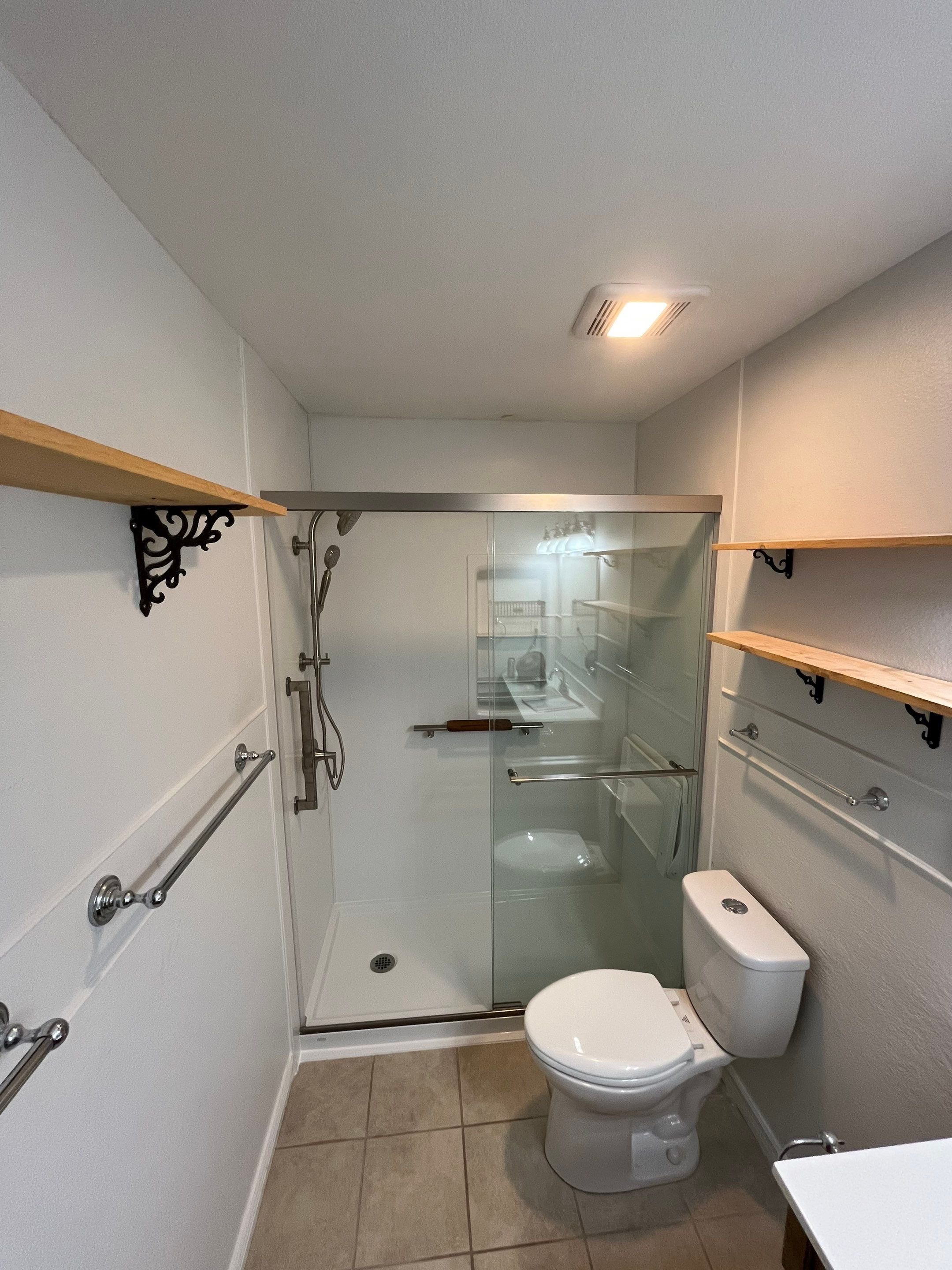 Small bathroom remodel on Carla Drive in Cheyenne, WY with walk-in shower, updated ventilation, safety grab bars, and space-saving layout