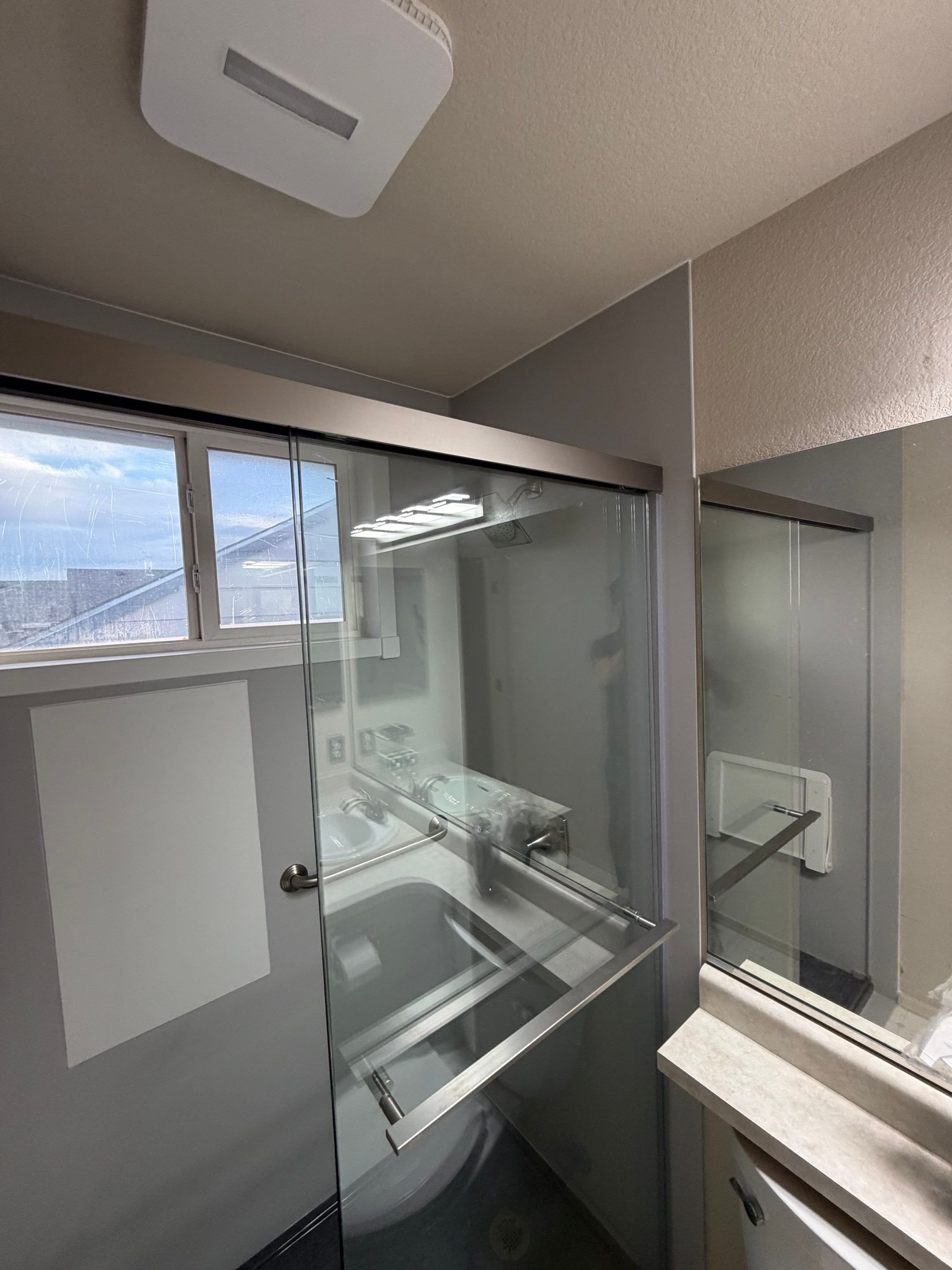 Bathroom shower replacement in a Colorado Springs home on Charlotte Parkway featuring a glass enclosure, updated fixtures, and improved moisture control