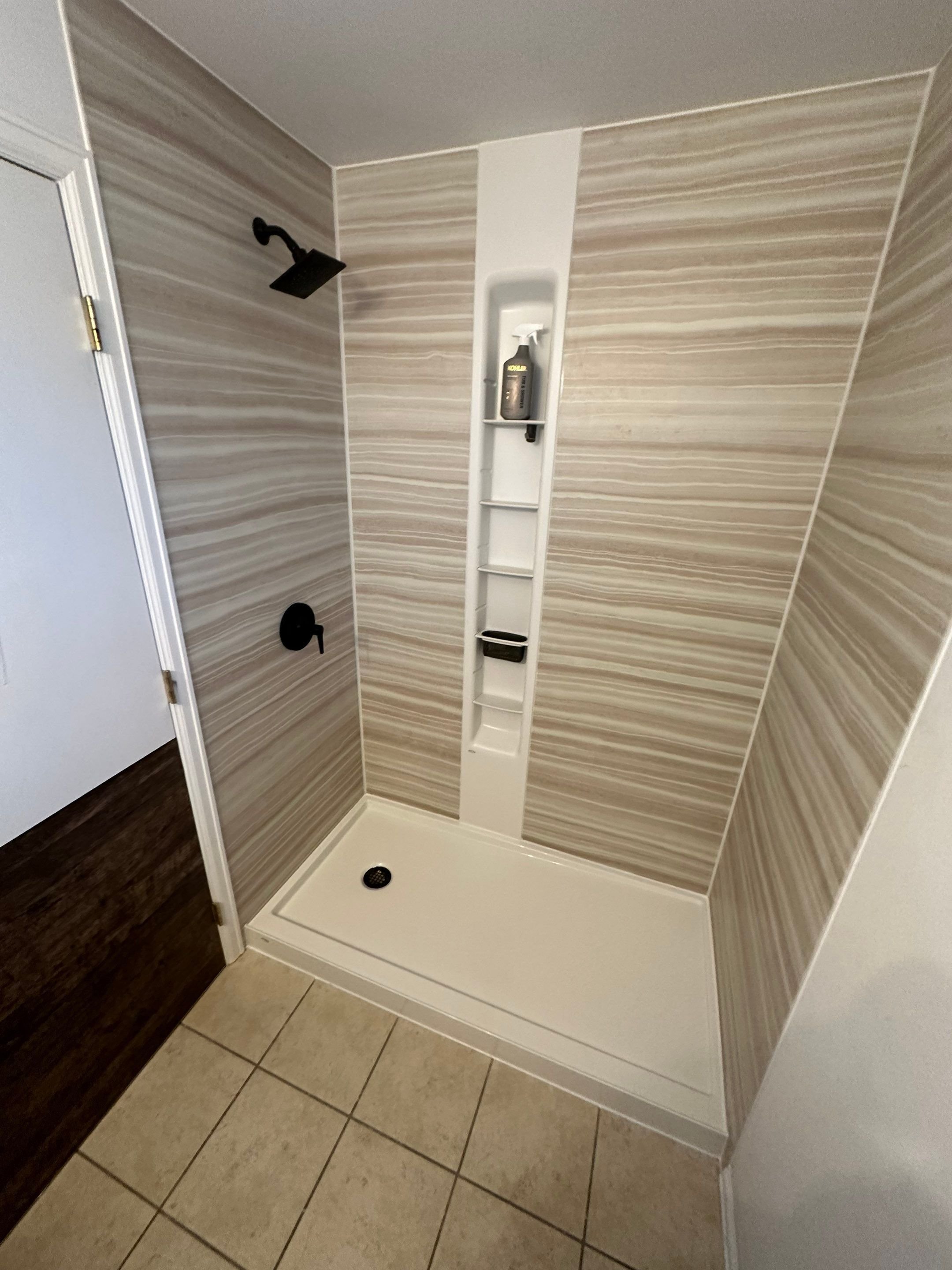 Modern walk-in shower installation on Cheyenne Avenue in Cheyenne, Wyoming with non-porous wall panels and low-maintenance shower base