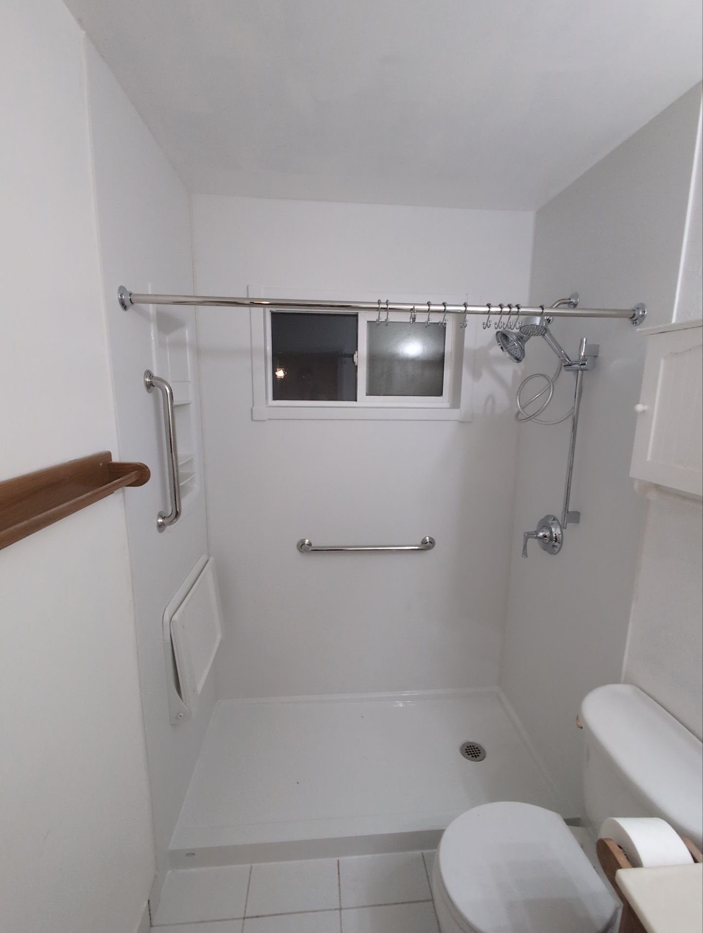 Bathroom remodel in Thornton on Ciancio Street featuring a walk-in shower with safety grab bars, low-threshold shower base, and improved ventilation for daily use.