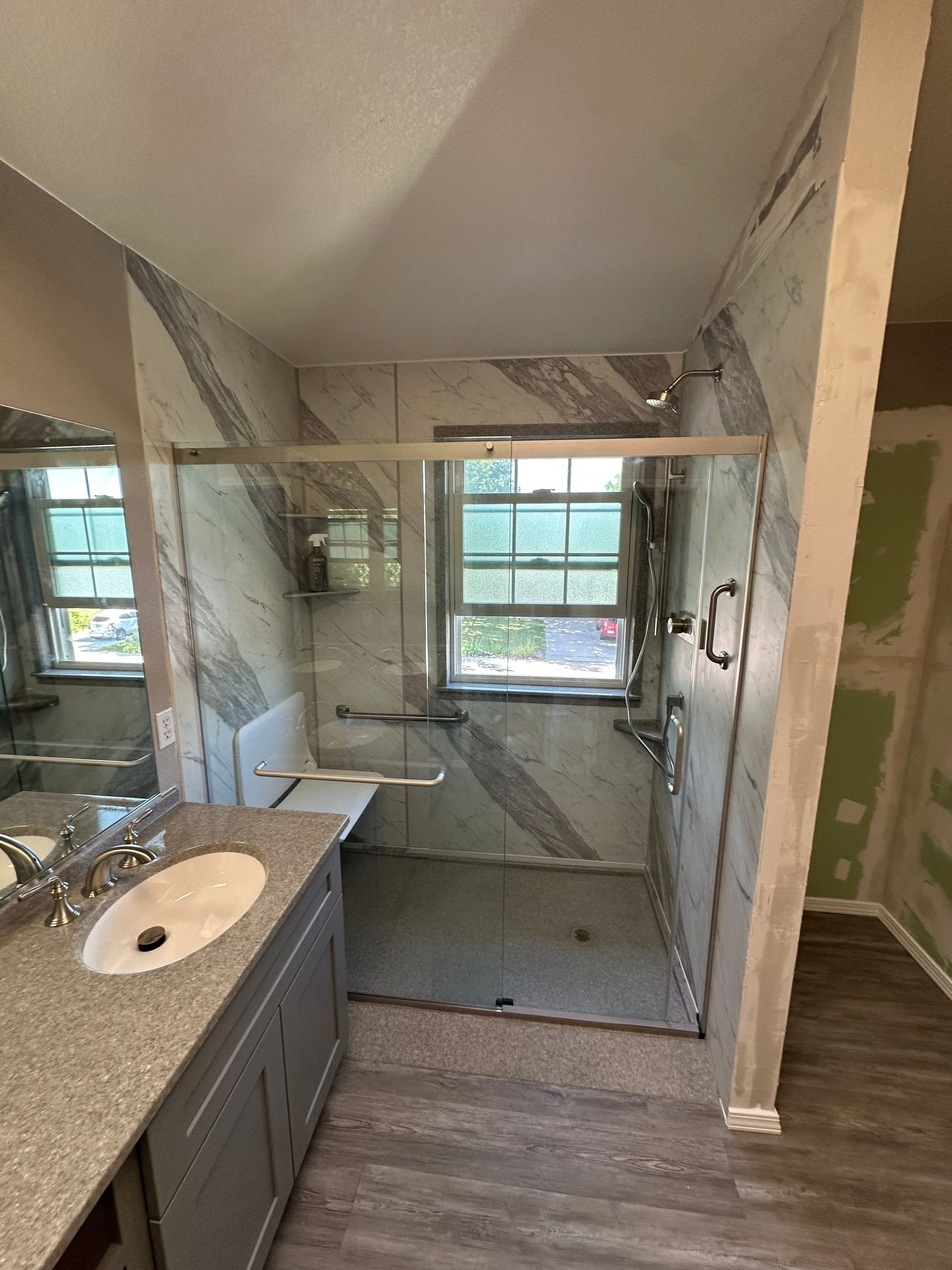 Custom walk-in shower remodel completed on E 127th Way in Thornton, including frameless glass doors, upgraded fixtures, and improved bathroom layout.