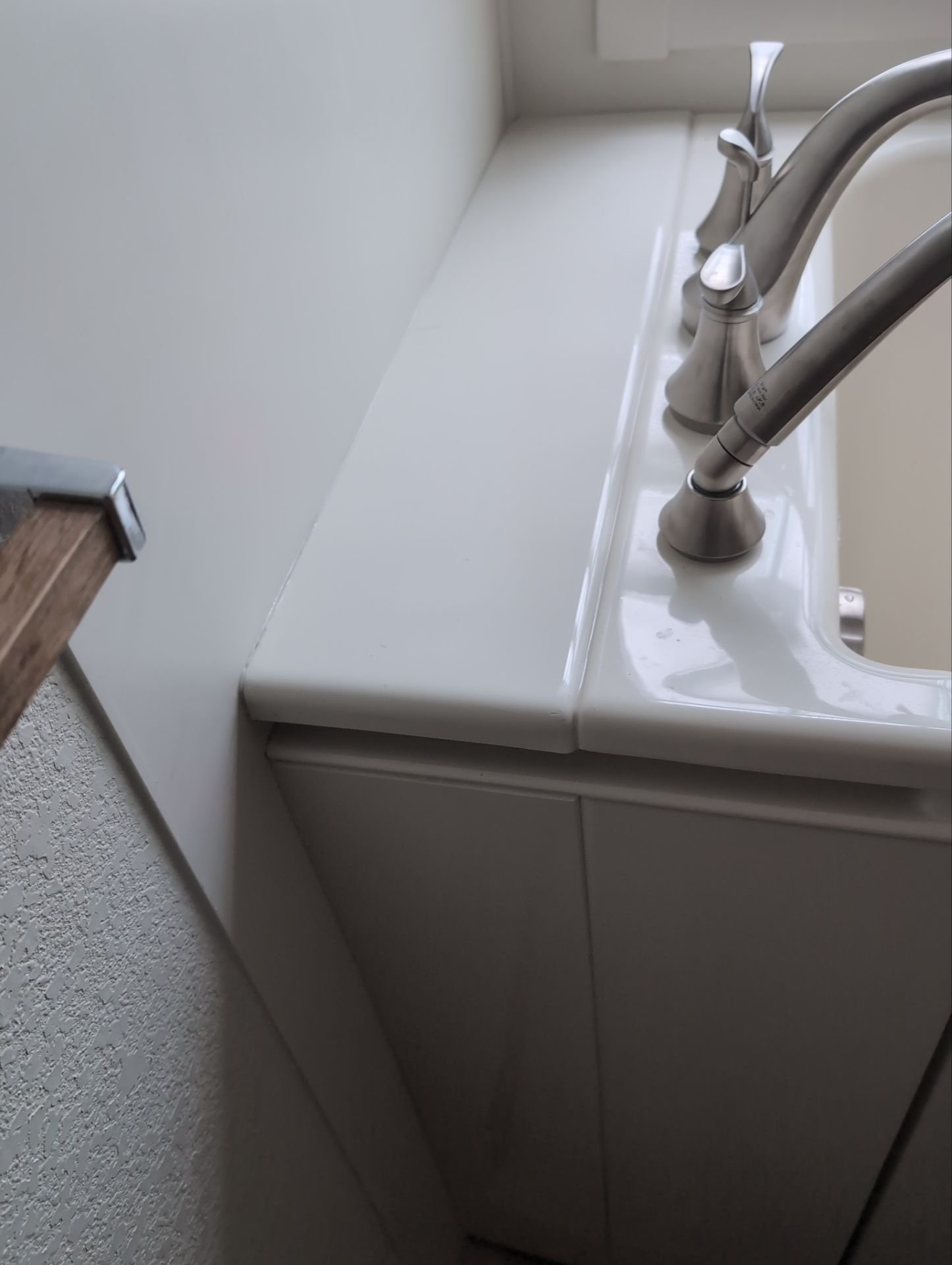 Brushed nickel Kohler faucet set installed on biscuit Kohler walk-in tub during a Niwot, CO bathroom remodel.