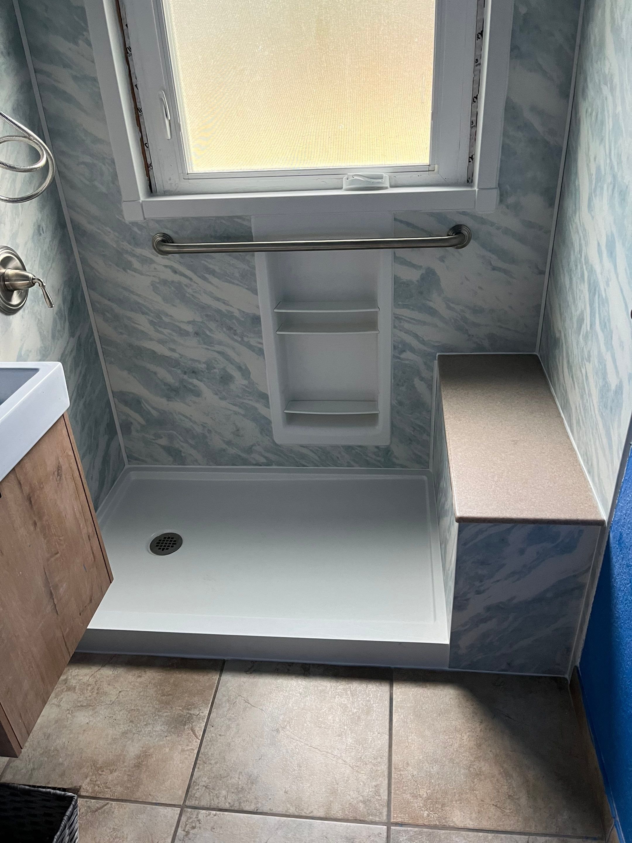 Denver walk-in shower installation on Flamingo Way featuring slip-resistant shower base, grab bars, and space-saving layout in an older home