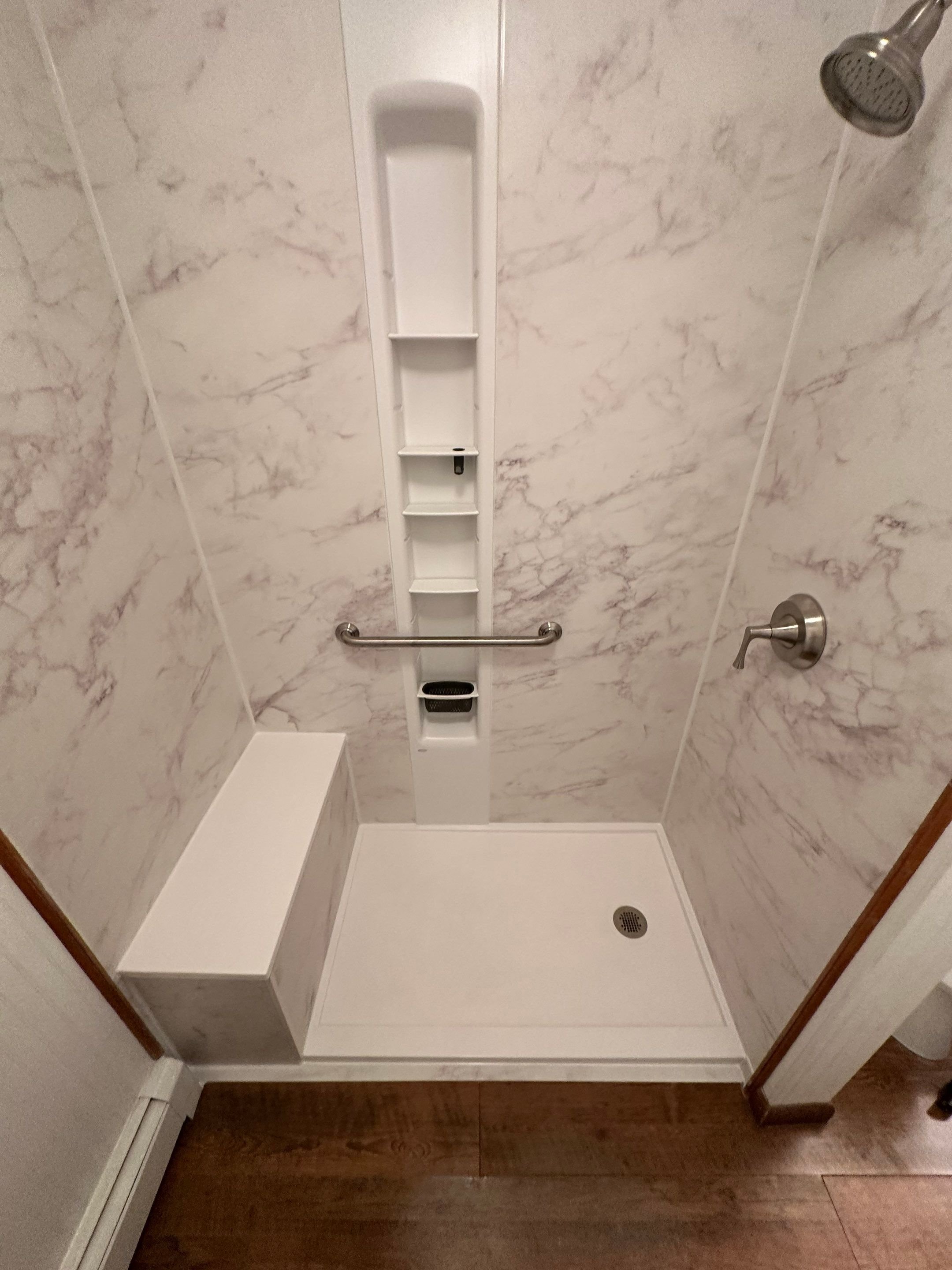 Walk-in shower installation on Greenleaf Drive in Grand Junction featuring a low-threshold base, built-in seat, and easy-clean wall system designed for daily use.