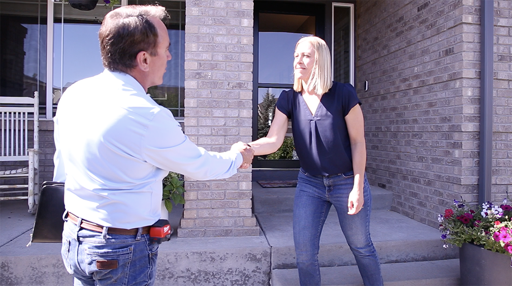 HomePride Bath designer greeting a Colorado homeowner at their front door for a bathroom remodel consultation.
