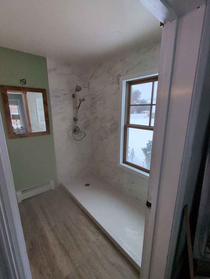KOHLER walk-in shower remodel in Eagle with solid surface walls and chrome fixtures