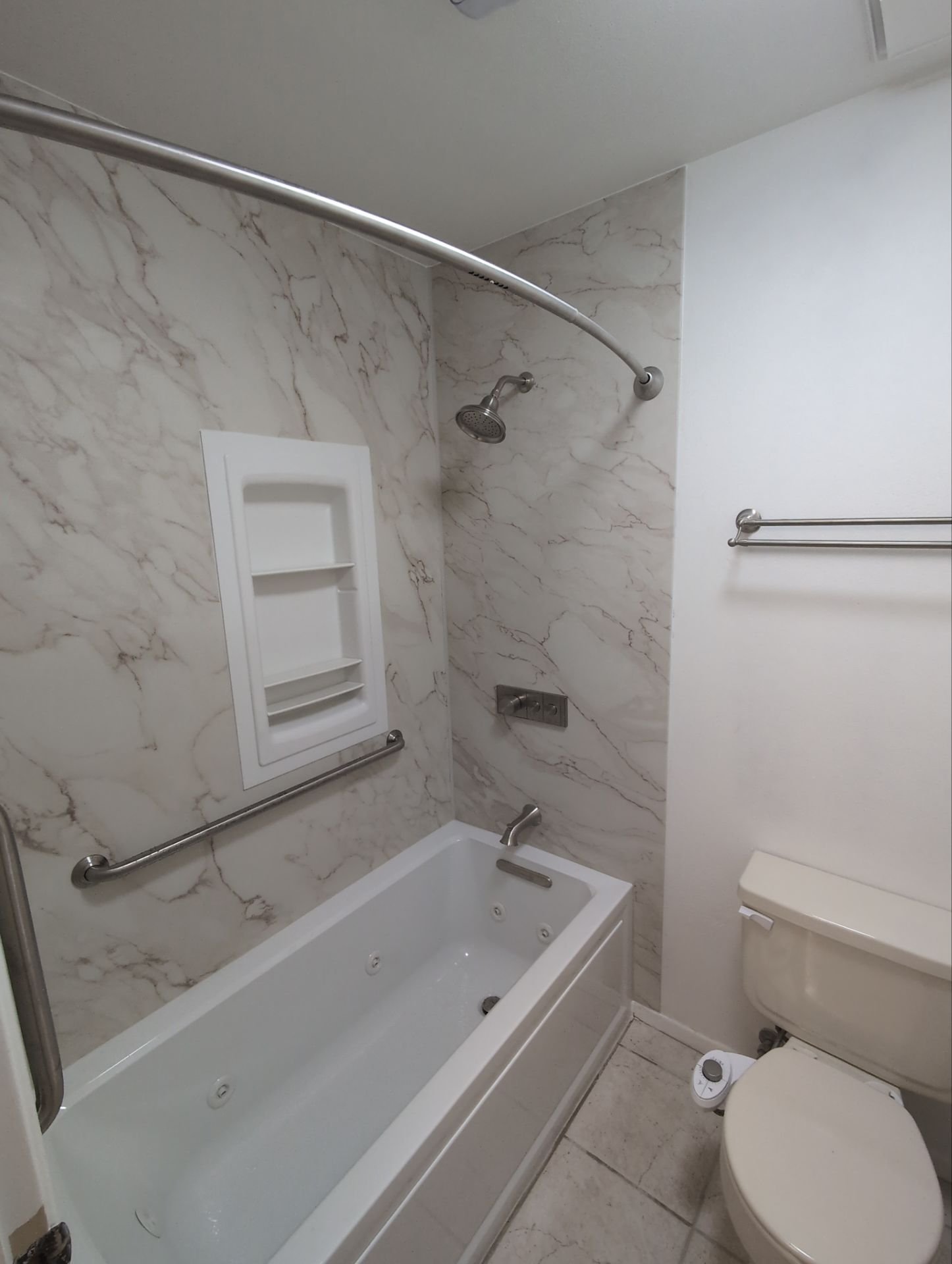 Updated bathtub surround in a Colorado Springs home on Little Pine Circle with moisture-resistant wall panels and modern fixtures