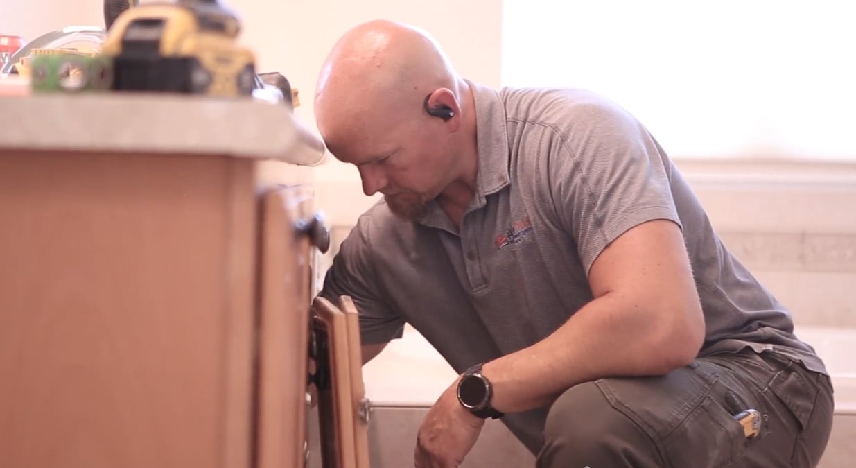 HomePride KOHLER-certified installer performing precision work during walk-in tub setup.