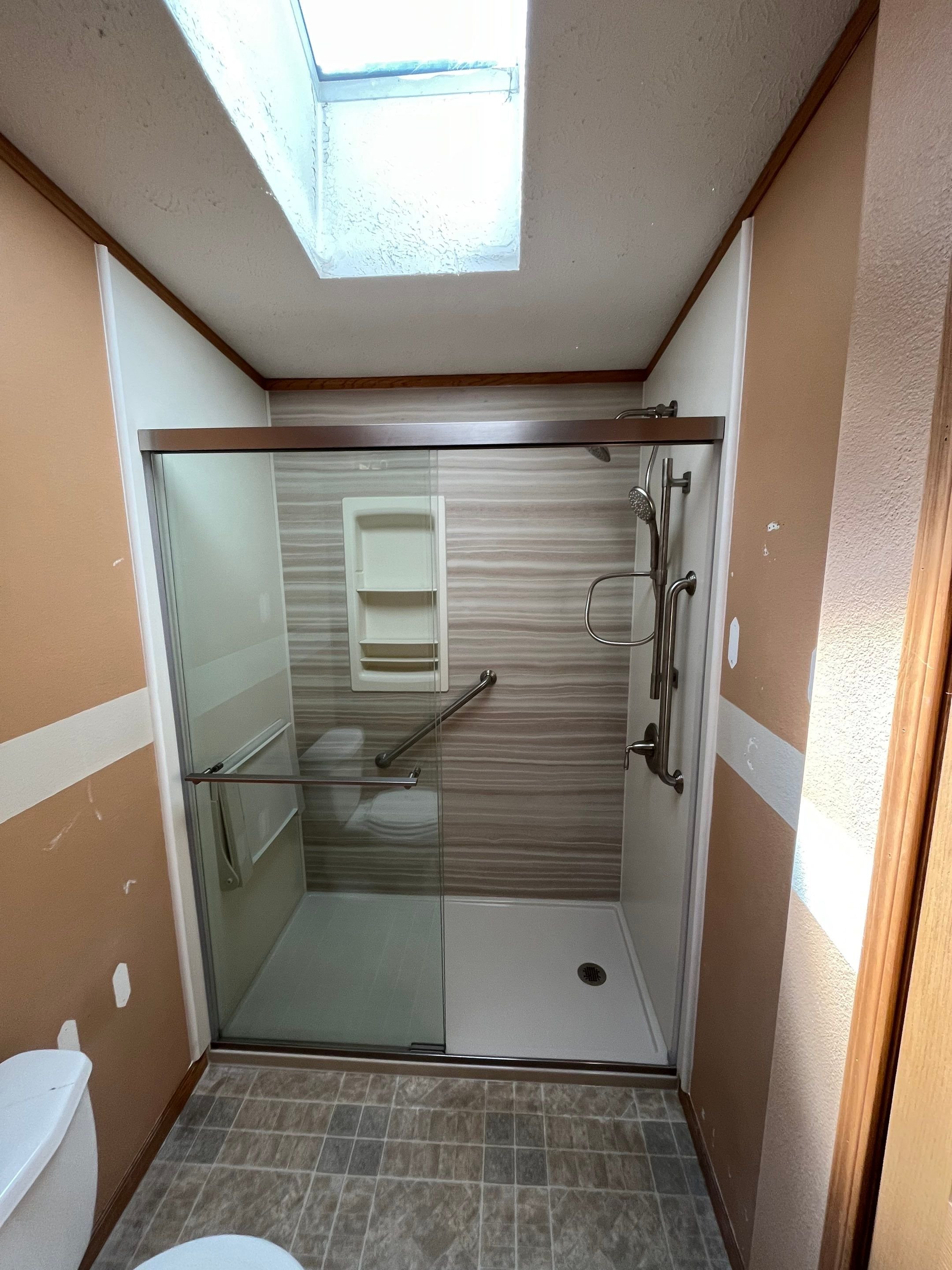 Curbless walk-in shower with accessibility features in an Ignacio, Colorado bathroom renovation