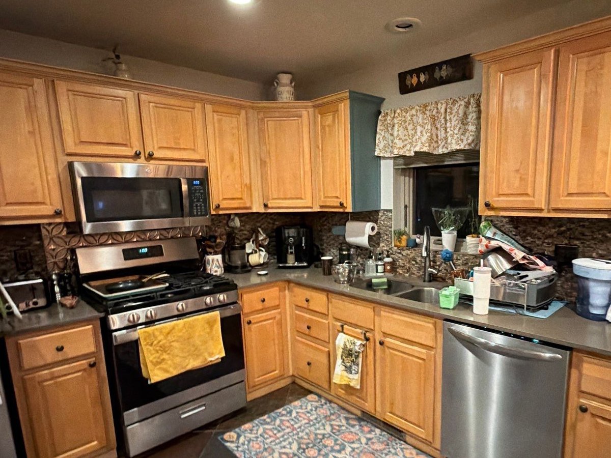 Before photo of contractor-grade maple kitchen cabinets before a cabinet remodel in a Steamboat Springs, Colorado home.