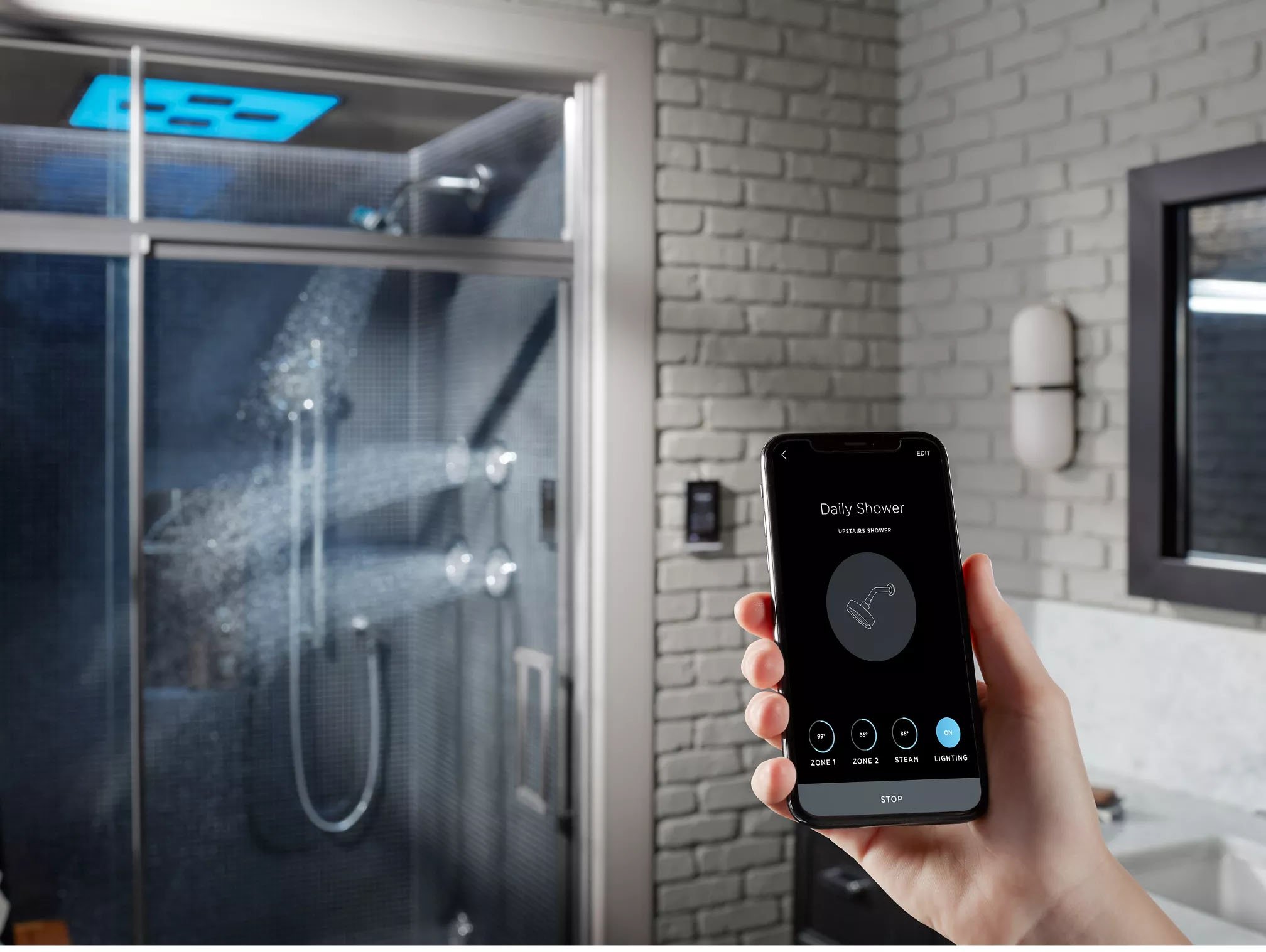“Smart shower system with digital touchscreen controls and rainfall head in a modern Colorado bathroom featuring KOHLER's DTV smart shower system and phone app 