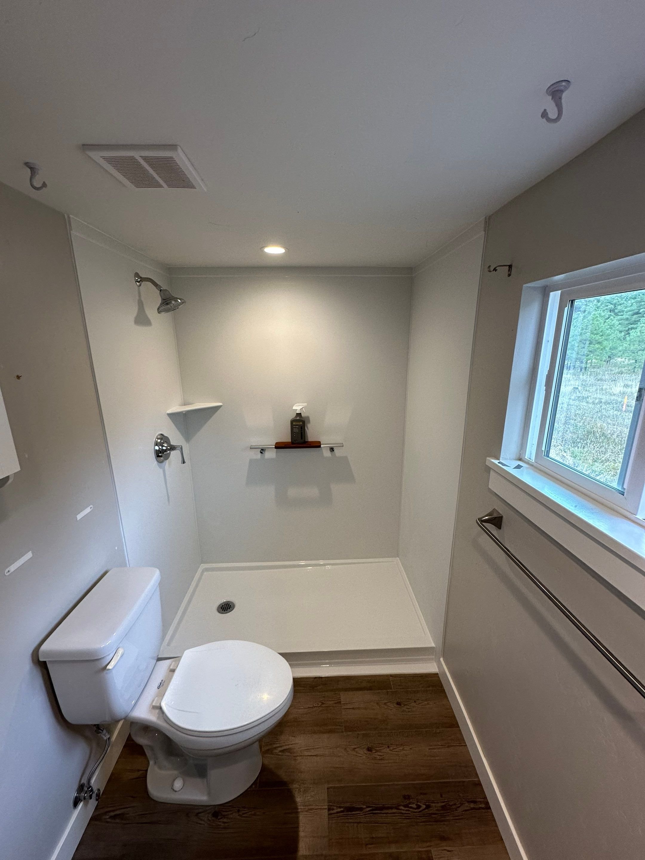 Tub-to-shower conversion in Pagosa Springs on Lake Street with walk-in shower base, non-porous wall panels, and improved ventilation