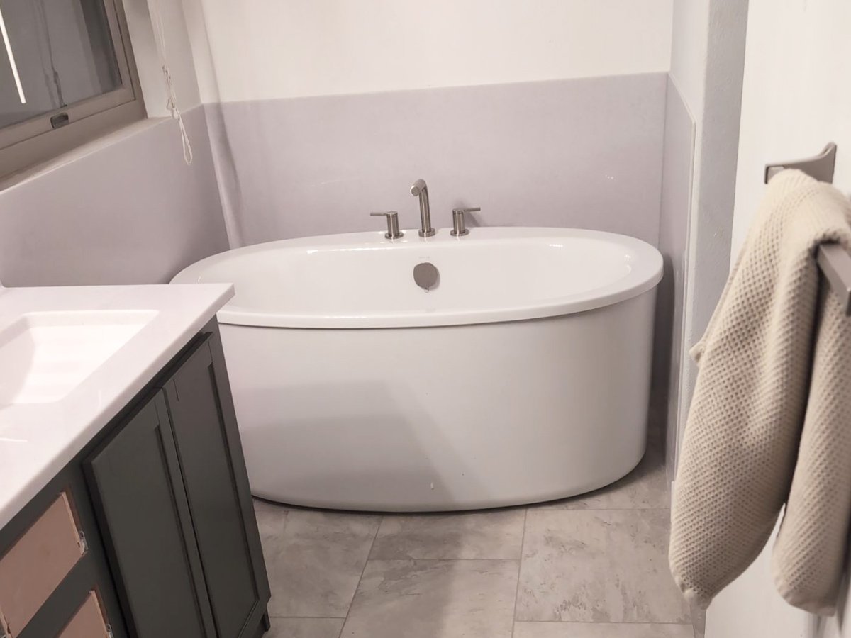 Freestanding soaking tub and custom vanity after a primary bathroom remodel in Steamboat Springs, Colorado.