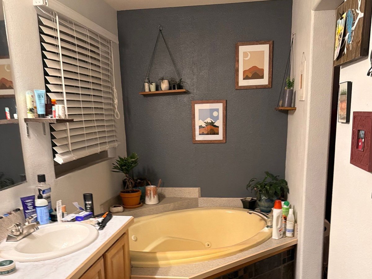 Before photo of the primary bathroom soaking tub and accent wall before a master bathroom remodel in Steamboat Springs, Colorado.