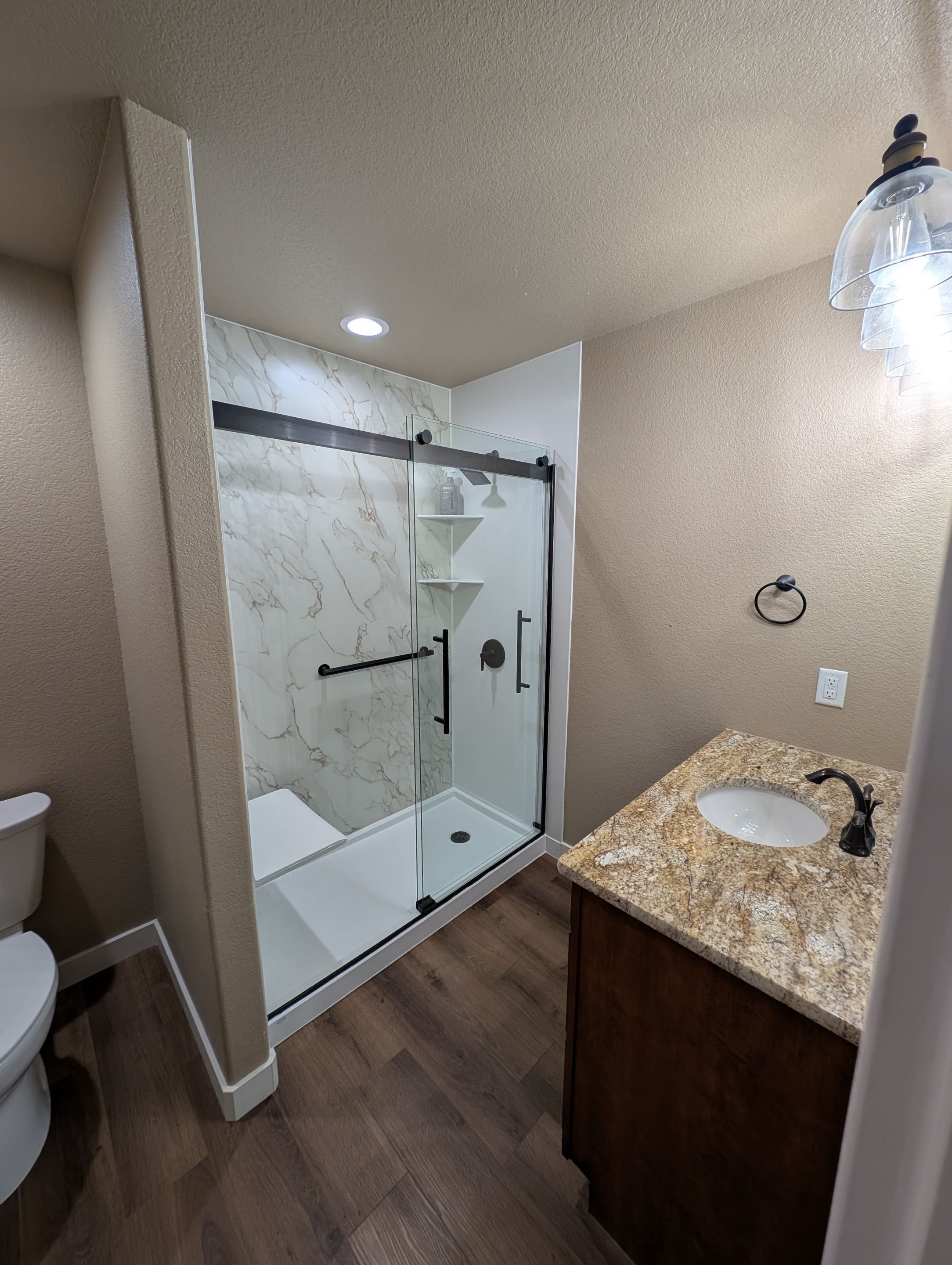 Accessible shower remodel in Pueblo, Colorado on North Will Rogers Drive with built-in seat, grab bars, and moisture-resistant surfaces