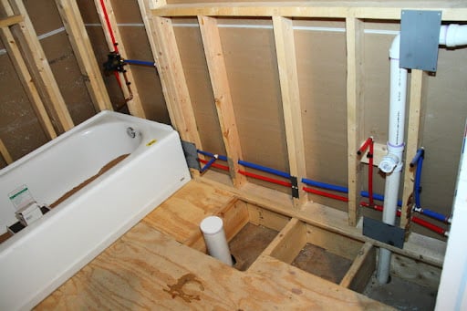 Bathroom remodel in progress with exposed plumbing and tub installation in Denver, Colorado