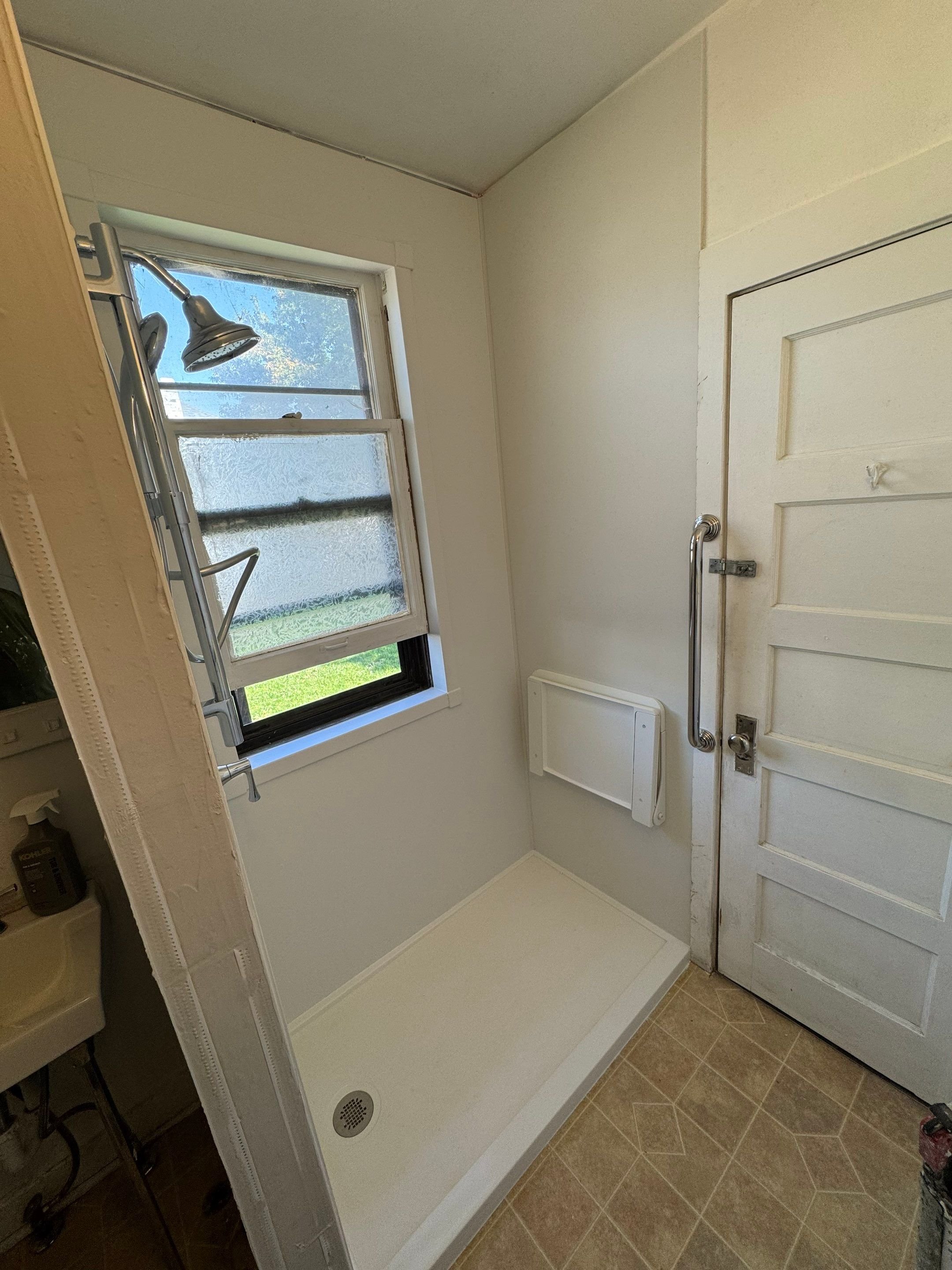Tub-to-shower replacement on Quivas Street in Denver featuring modern glass enclosure, updated shower fixtures, and space-efficient bathroom layout