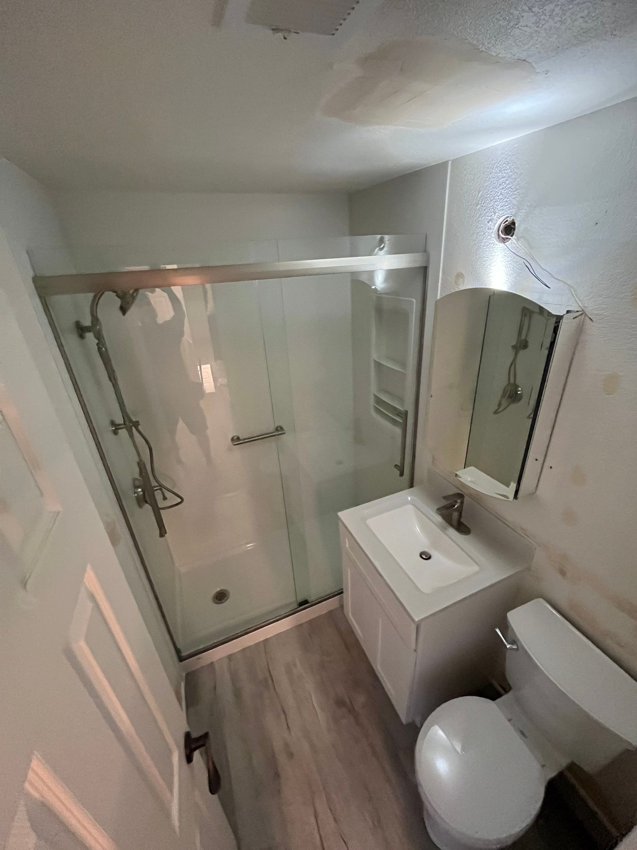Small bathroom remodel on S Pierson Street in Lakewood featuring a walk-in shower replacement, updated vanity, waterproof flooring, and improved ventilation.