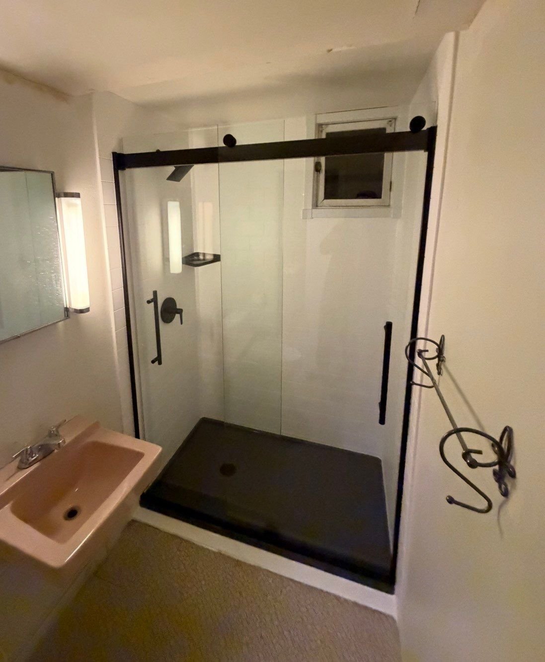Shower remodel in a Lakewood home on S Reed Street with a low-threshold shower base, glass enclosure, upgraded fixtures, and moisture-resistant wall systems.