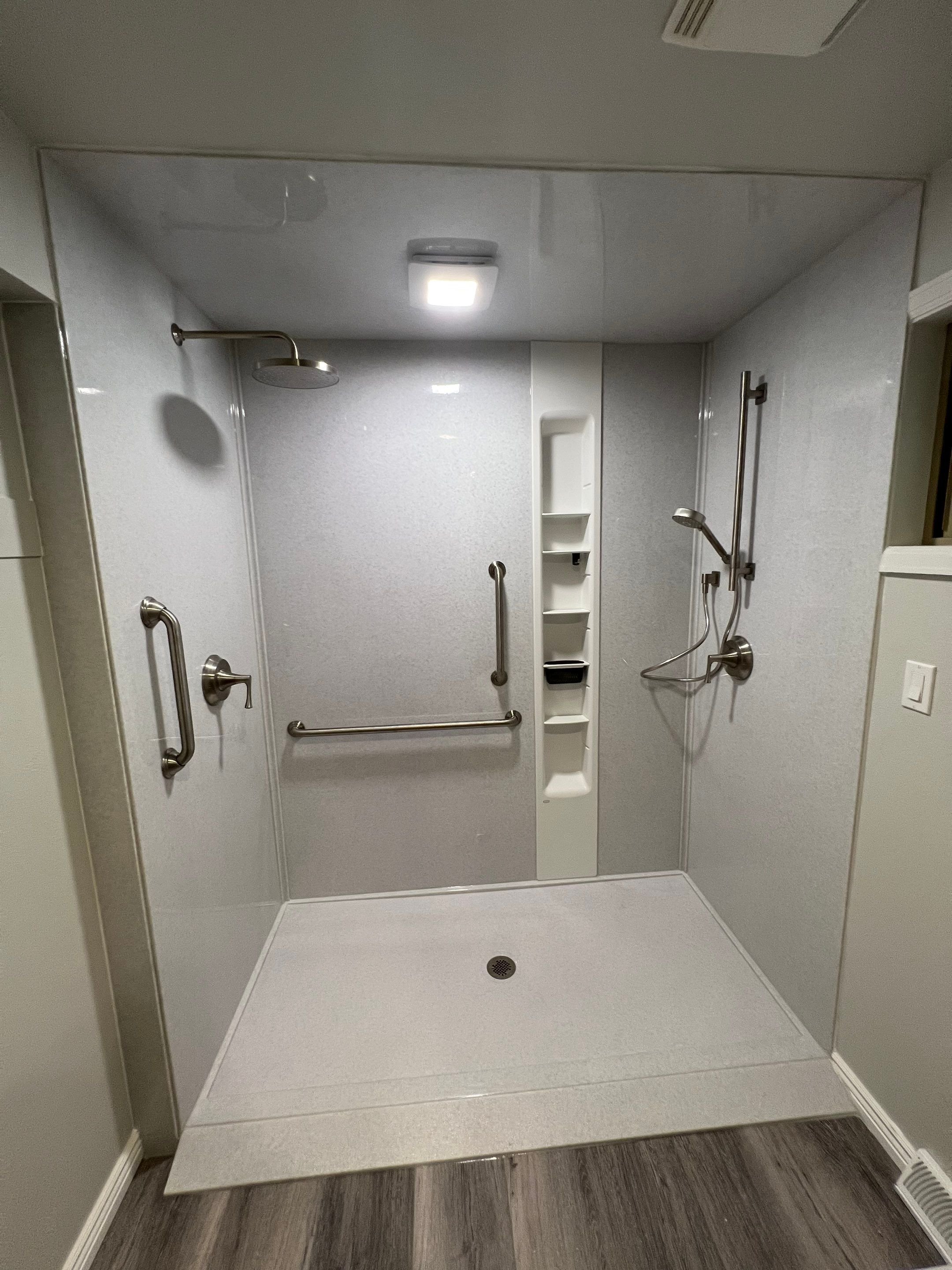 Bathroom remodel in Littleton, CO on Saulsbury Street with an upgraded tub surround, improved ventilation, and materials built for daily use.