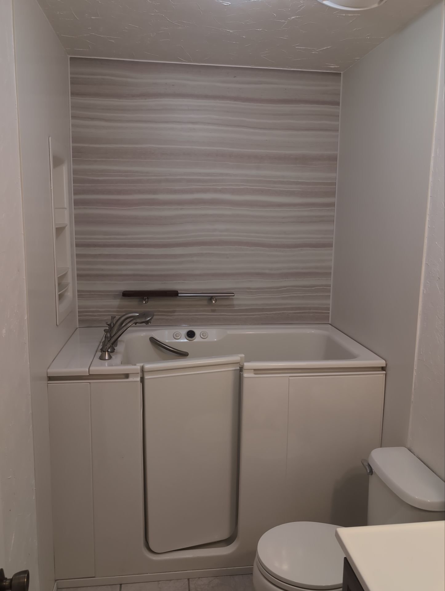 Walk-in tub installation on Shane Court in Grand Junction with a wide entry door, built-in grab bar, and water-resistant wall panels for safe bathing.