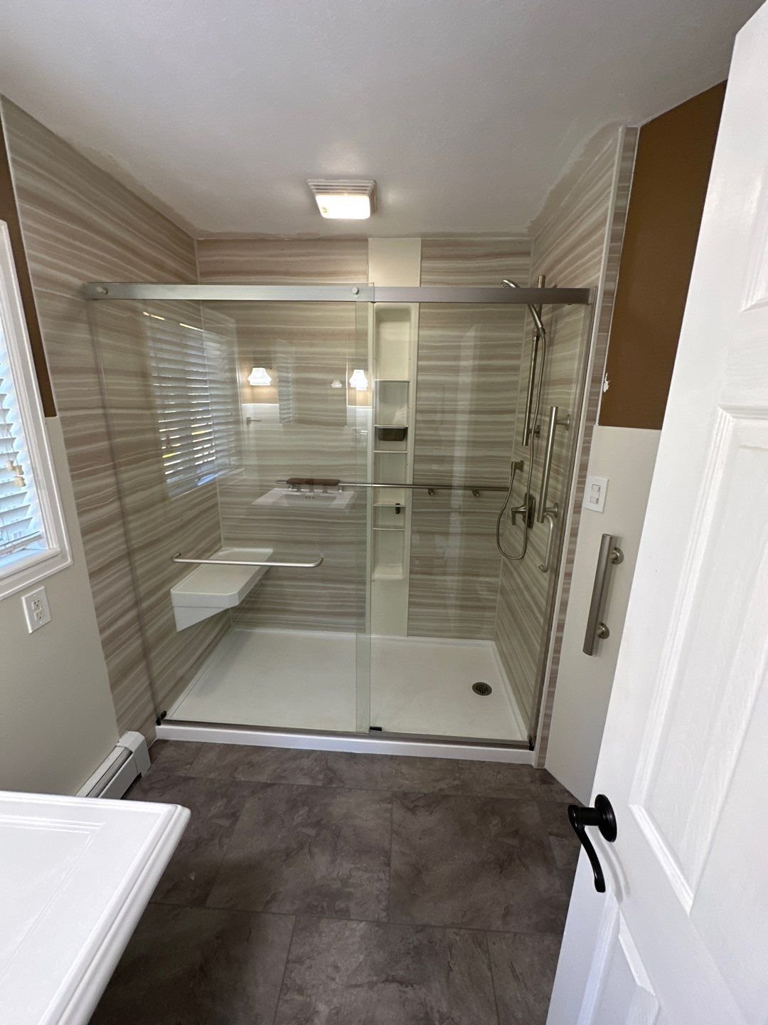 Walk-in shower installation on Simms Street in Lakewood featuring a spacious shower pan, modern glass enclosure, and easy-to-clean wall panels designed for daily use.