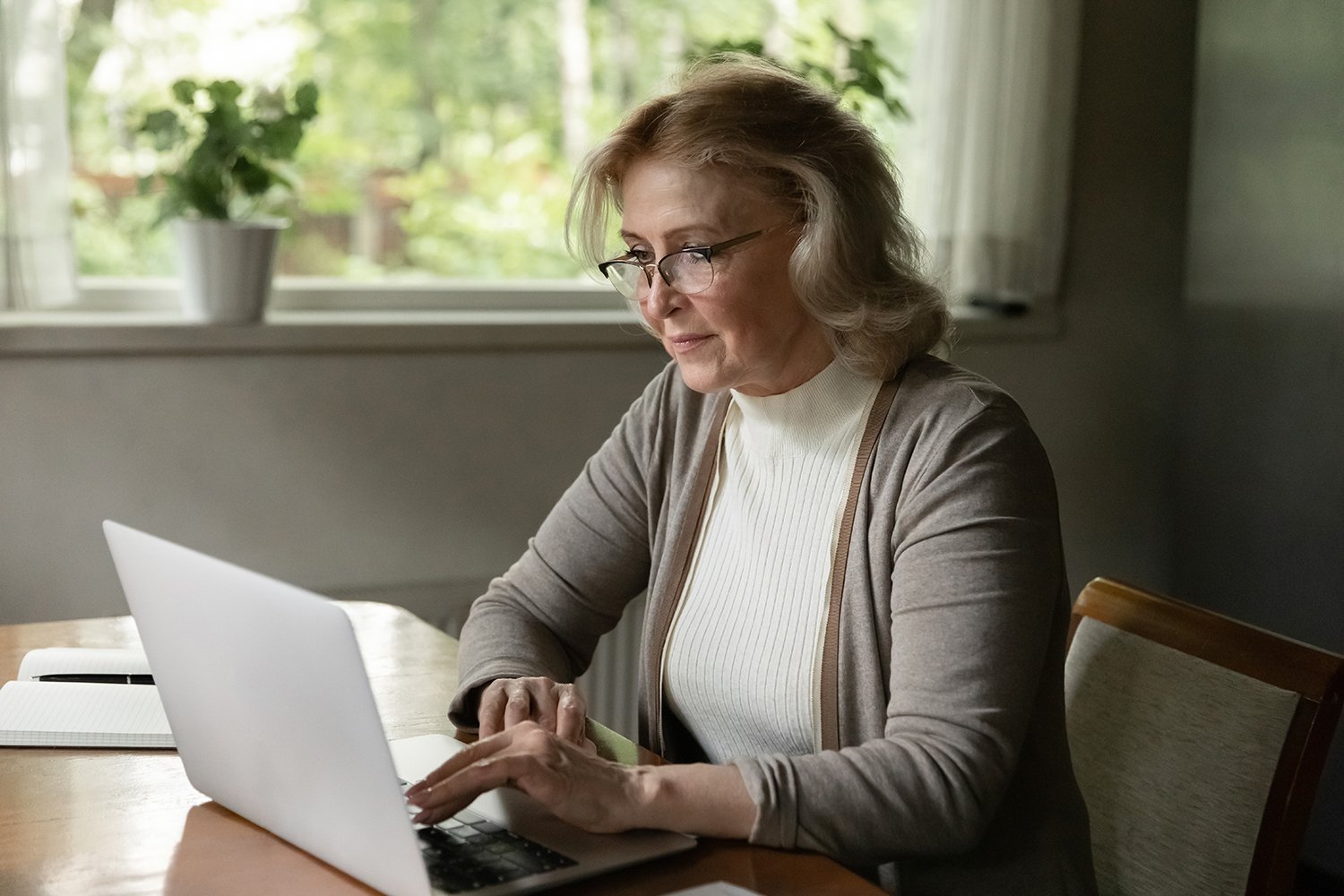 Colorado homeowner reviewing a detailed bathroom remodel contract with modern walk-in shower in background, emphasizing contractor verification and trust.