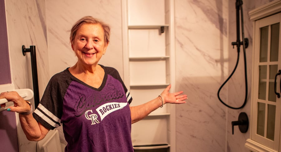 Smiling Littleton CO homeowner Trish McDaniels in her new KOHLER walk-in shower installed by HomePride