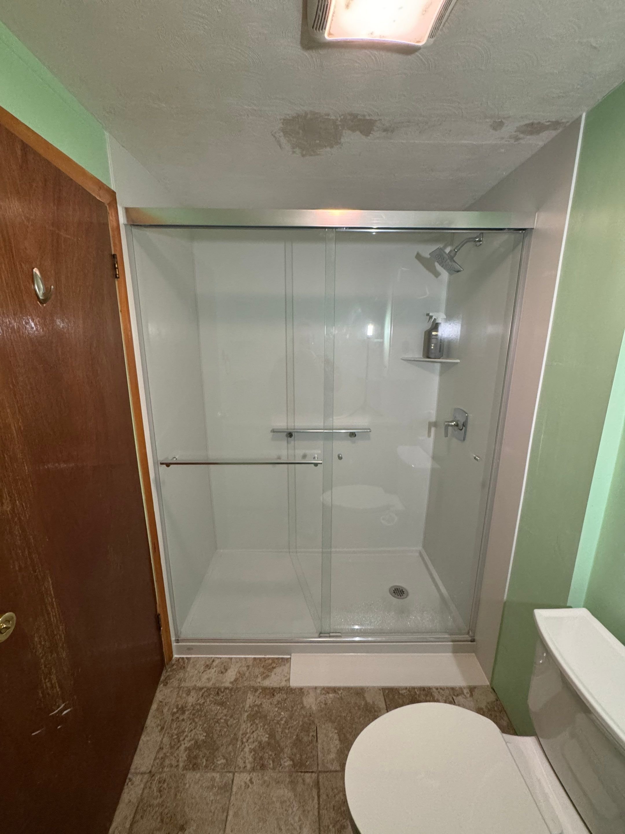 Updated walk-in shower with moisture-resistant wall panels in a Southwest Colorado bathroom remodel
