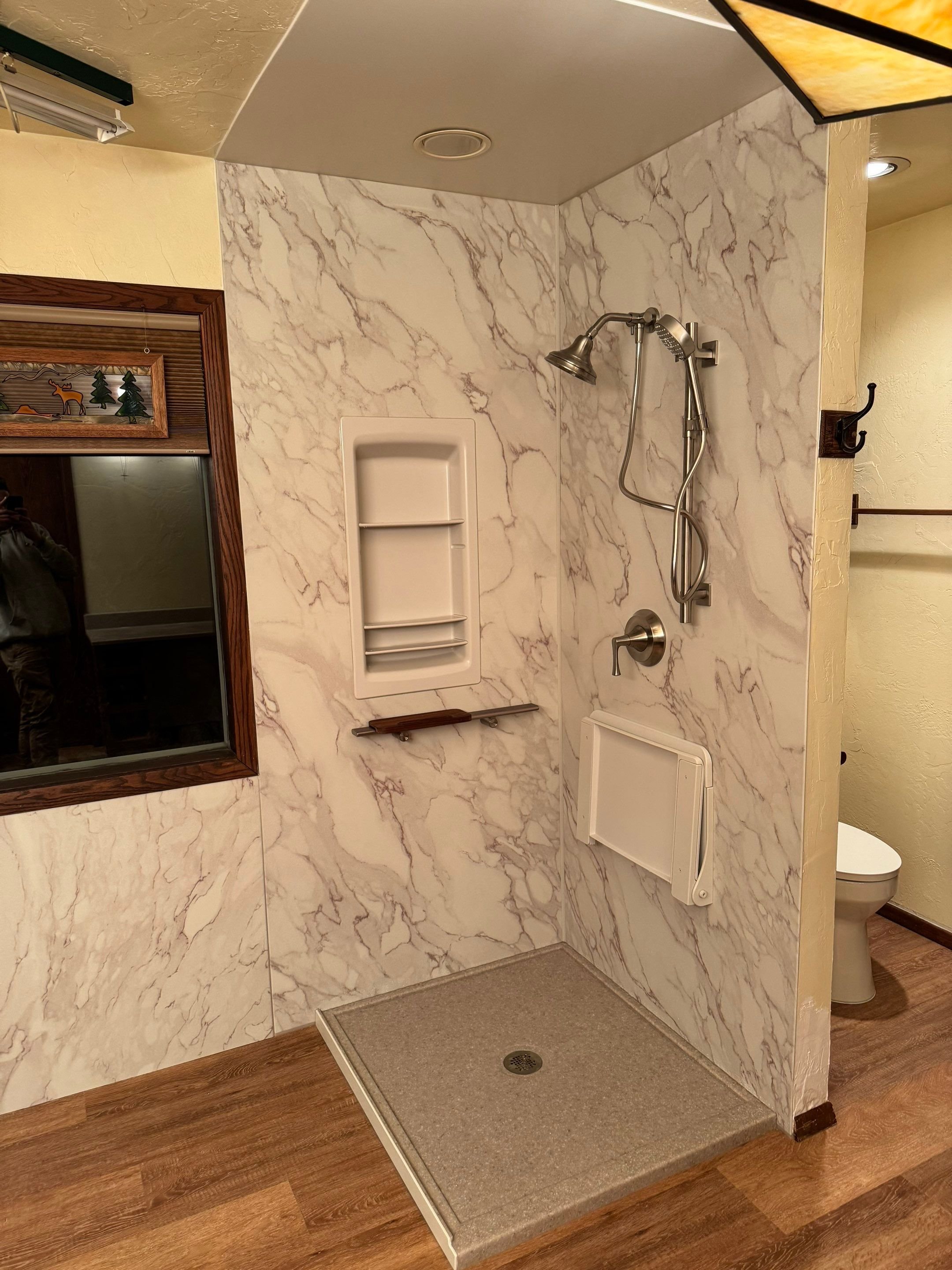 Barrier-free shower remodel with slip-resistant base and glass enclosure near Durango, Colorado
