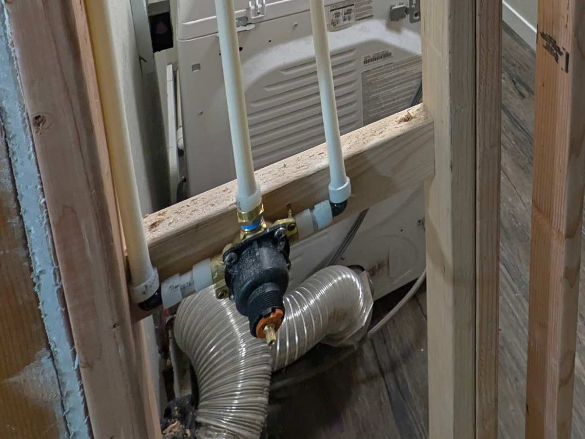 New shower valve installed in open framing during a bathroom remodel