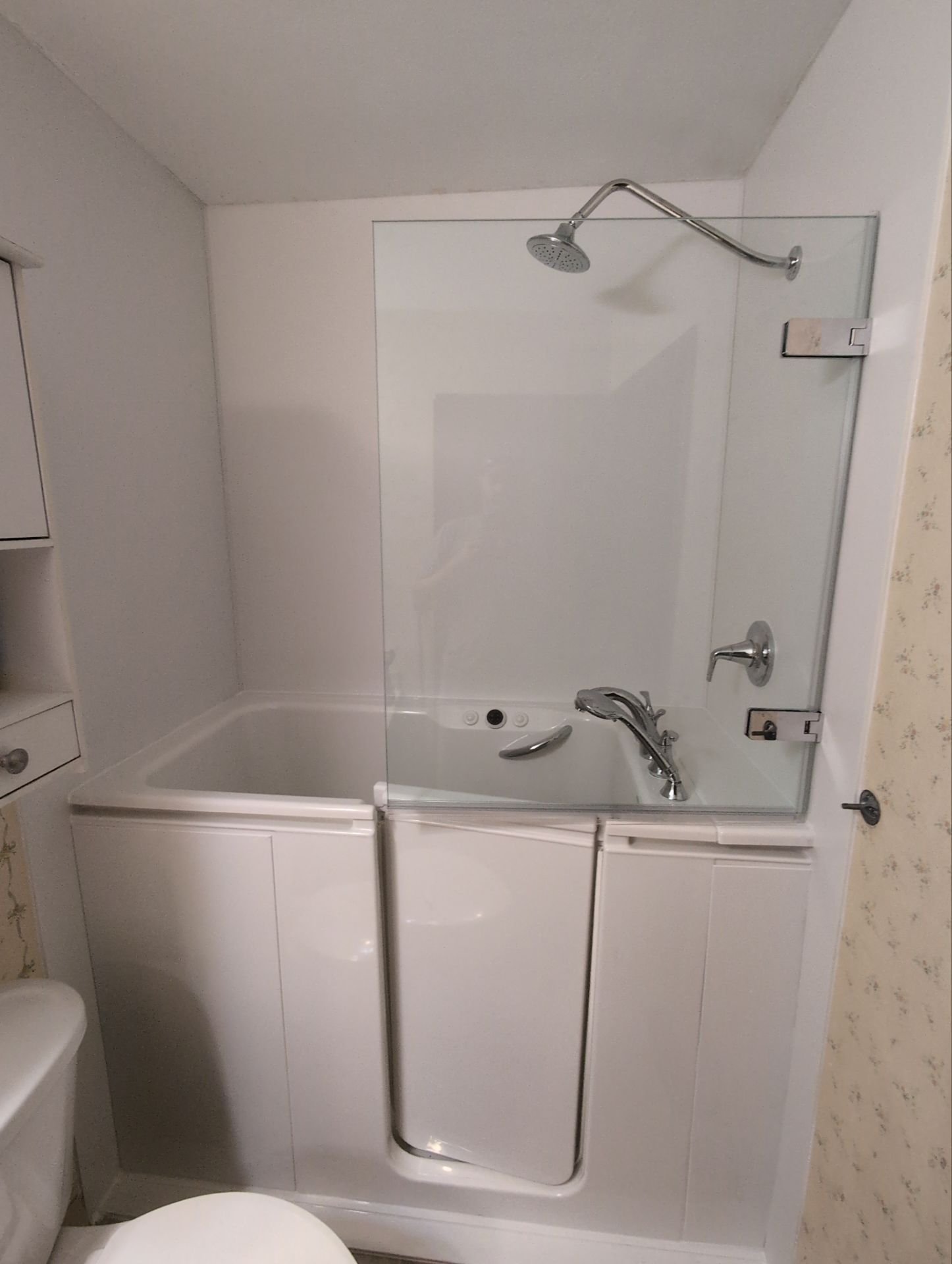Walk-in bathtub installation with glass shower screen and chrome fixtures in Aurora, CO – aging-in-place bathroom remodel.