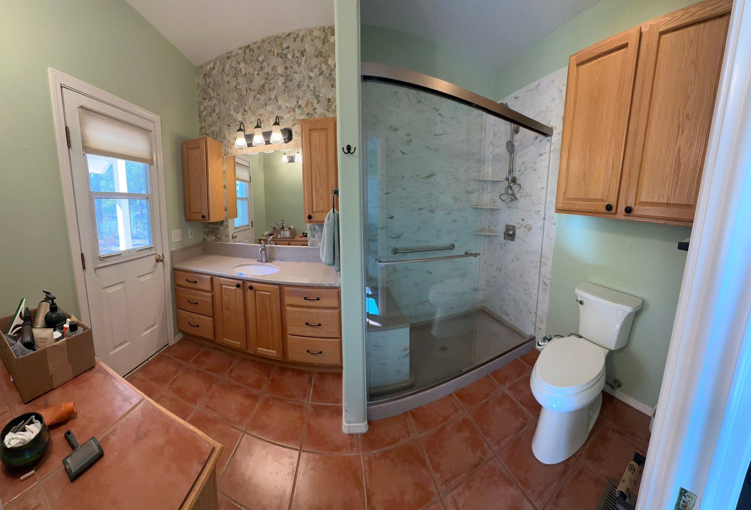 Bathroom remodel in Pagosa Springs on Woodsman Drive with walk-in shower, safety grab bars, upgraded vanity, and moisture-resistant materials